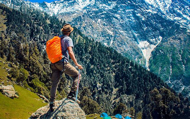 Man Climbing the hills and Watching the Cliffs