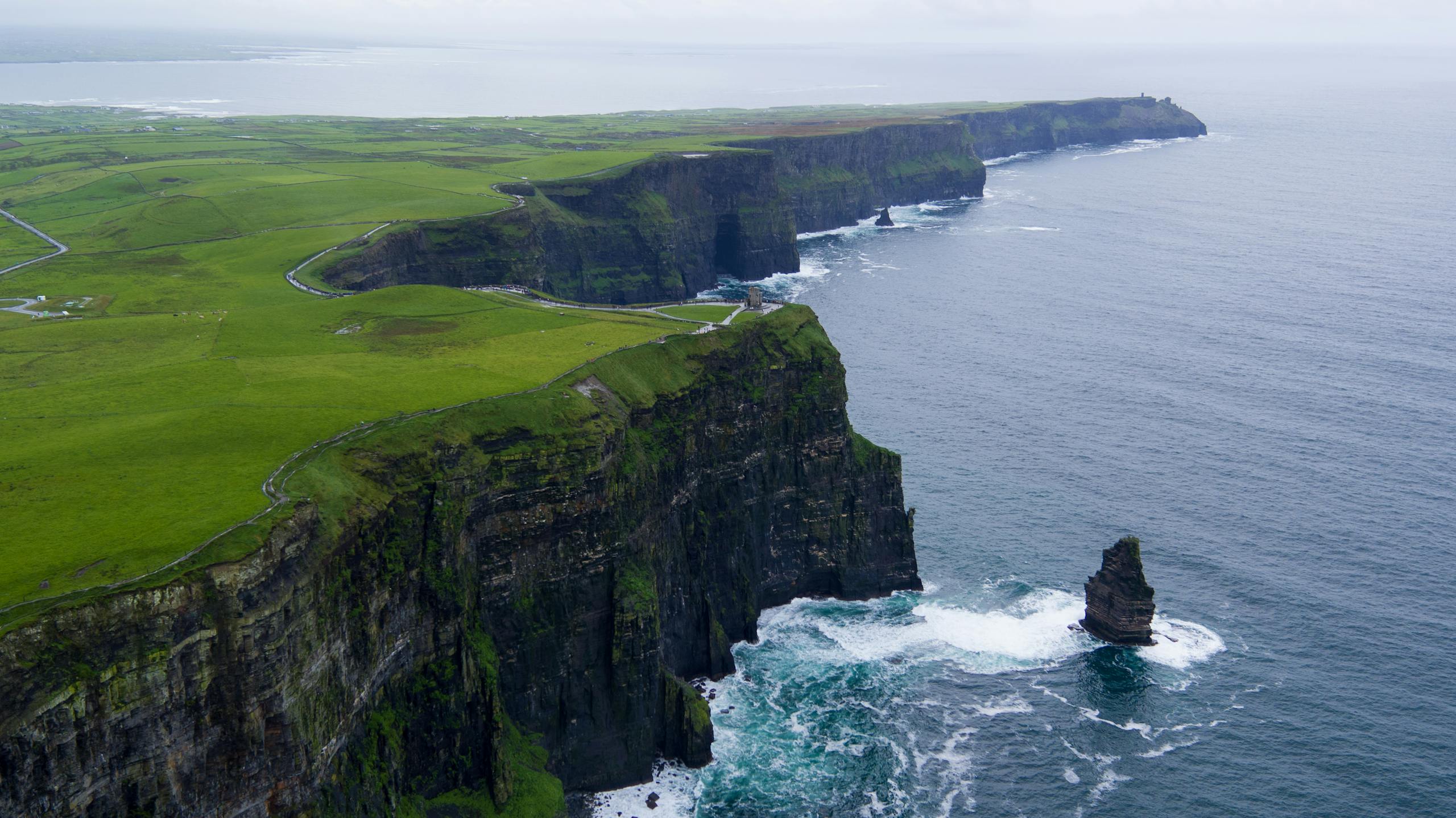 Aerial Photography of Rock Next to water body - The Explore Horizon