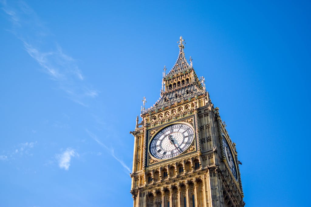 Low Angle View of Clock Tower Against Blue Sky - The Explore Horizon