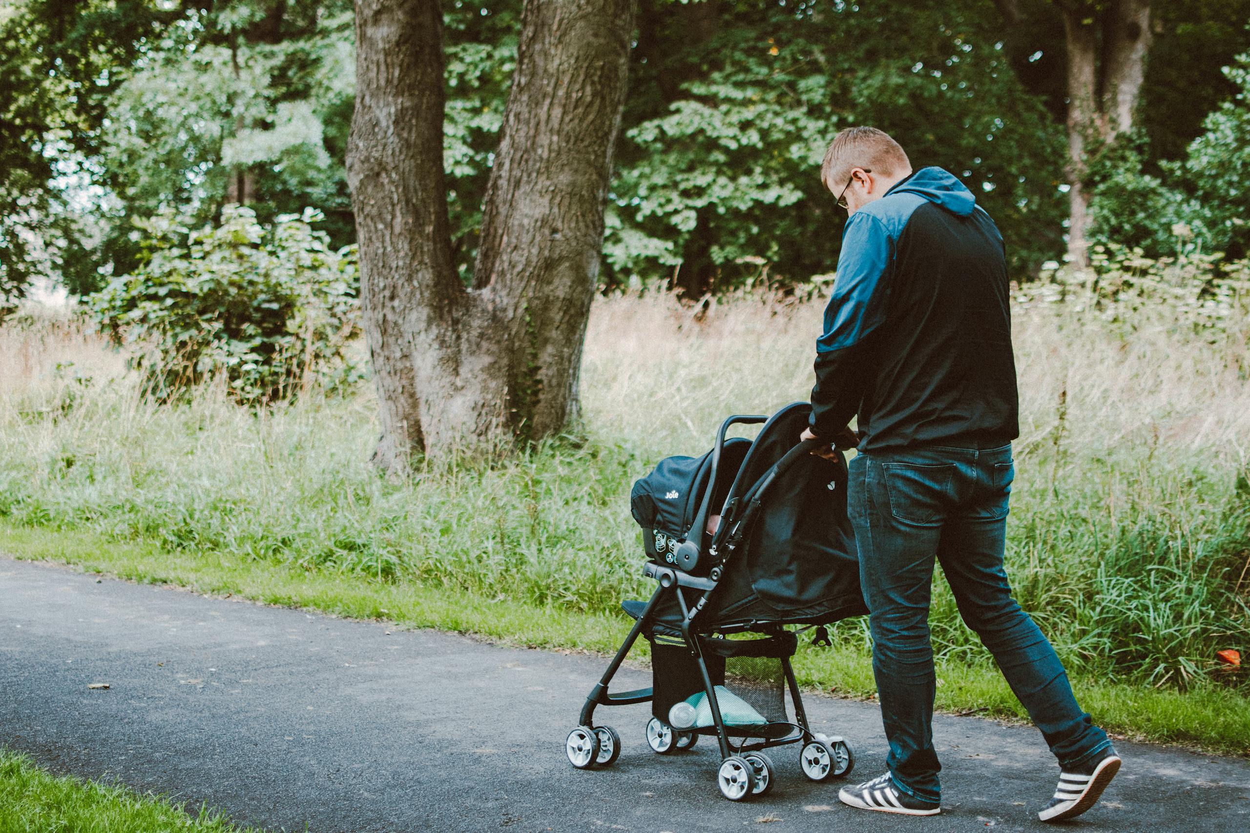 Photo of Man Pushing Baby on Stroller on Permeable Pavement - The Explore Horizon