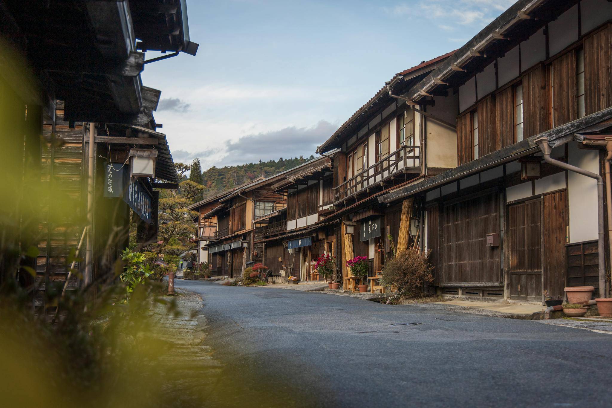 Traditional authentic oriental old houses in row located in village surrounded by mountain forest