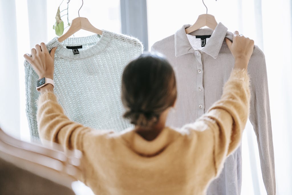 Unrecognizable woman demonstrating clothes in store - The Explore Horizon