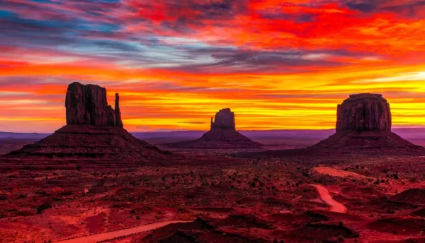 A breathtaking sunset over Monument Valley, showcasing its iconic rock formations and vibrant sky colors | Monument Valley Photos: A Spectacular Visual Treat - The Explore Horizon