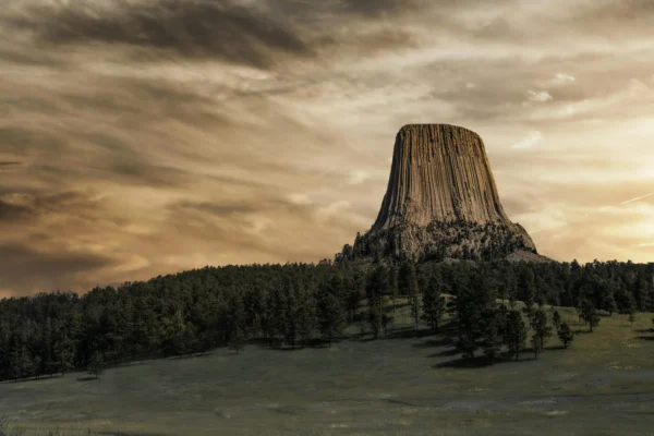 Devil's Tower rises dramatically, showcasing its unique geological formations within the Ultimate Devils Tower Epic National Monument. | Ultimate Devils Tower Epic National Monument - The Explore Horizon